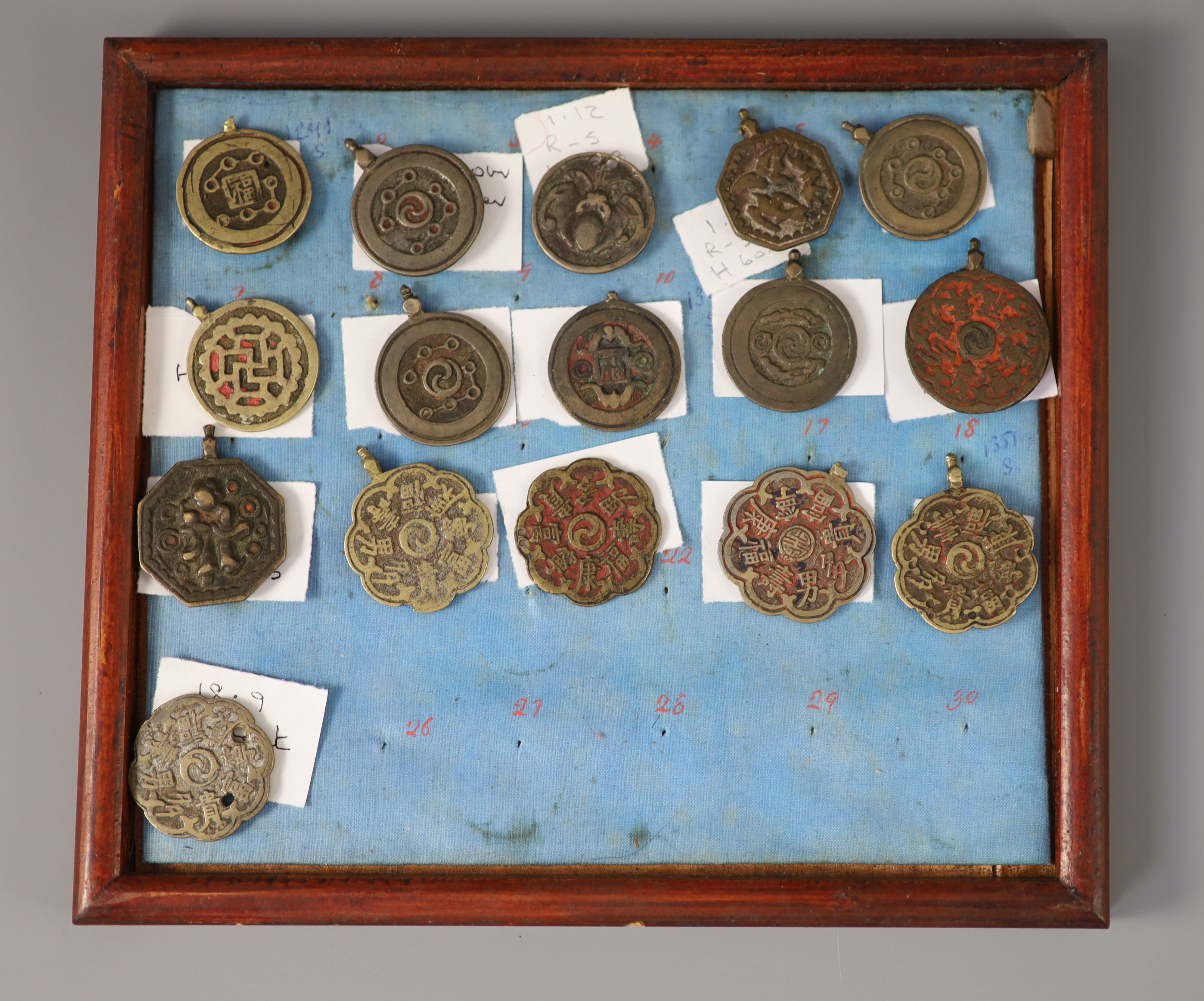 A group of 99 Korean bronze and metal amulets or charms, 19th/20th century